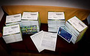 Postcards stacked and bundled with Every Door Direct paperwork on top of each stack
