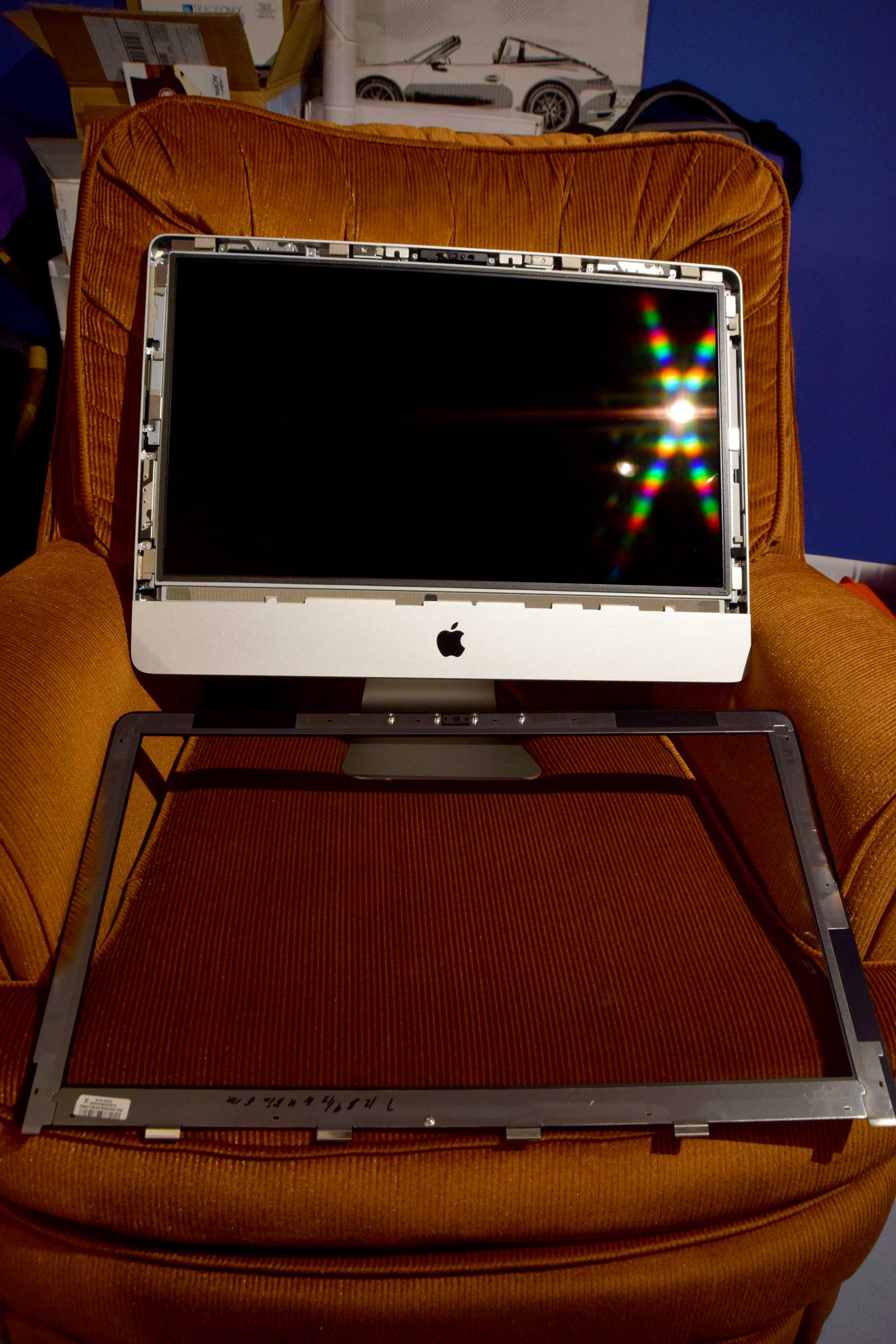 Photo showing iMac partially reassembled and waiting for glass to be installed over the screen.