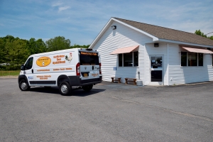 Photo of Mom and Pop's Cafe catering van with graphics designed and applied by SillyCar Design in front of the restaurant.