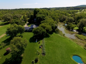 Aerial photo of backyard with creek at property in Canajoharie, New York.