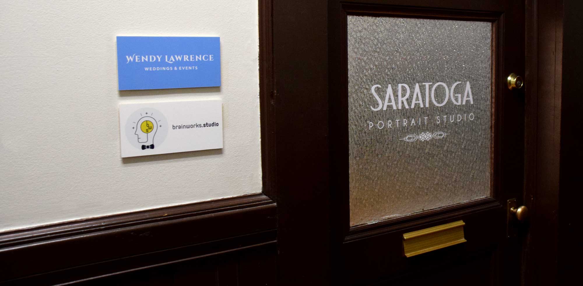 Photo of wall and glass door signage for Wendy Lawrence Weddings & Events, Brainworks Studio and Saratoga Portrait Studio.